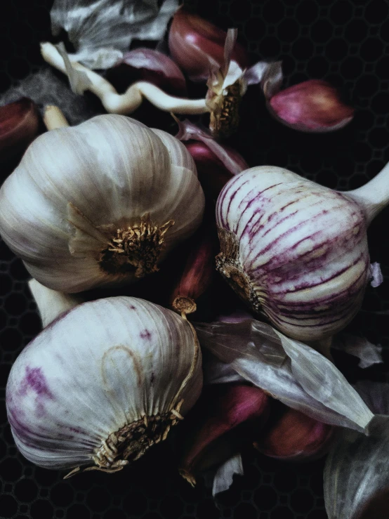 a bunch of garlic sitting on top of a table, a macro photograph, by Kristin Nelson, trending on unsplash, renaissance, magenta and gray, 💋 💄 👠 👗, soup, devil's horns