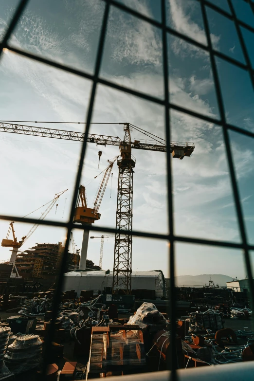 a view of a construction site through a fence, pexels contest winner, sitting in a crane, high quality product image”, multiple stories, cinematic wide shot