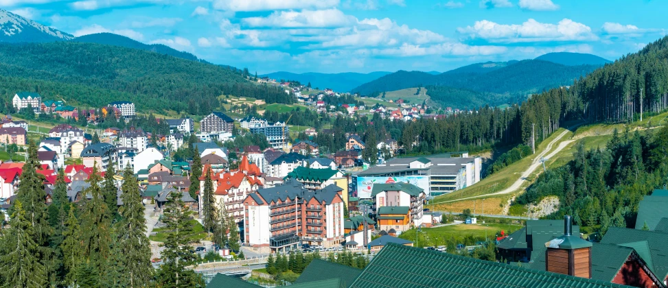 a view of a town with mountains in the background, a photo, carpathian mountains, profile image, square, psychedelic ski resort