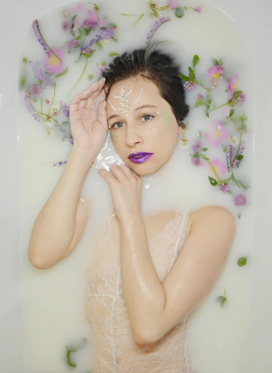 a woman in a bathtub with flowers on her head, an album cover, trending on pexels, purple lipstick, dilraba dilmurat, milk - bath effect, ethereal white dripping tar