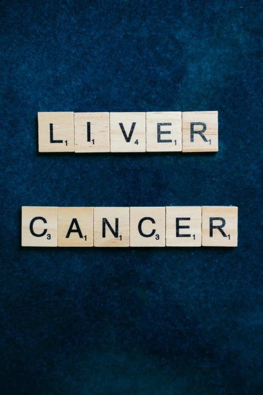 two scrabbles spelling liver cancer on a blue background, an album cover, panel, 4l, canva, us