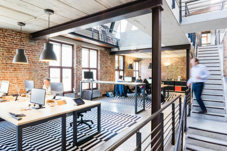 a room filled with lots of desks and computers, pexels, modernism, steel archways, interior of a loft, profile image, 9 9 designs