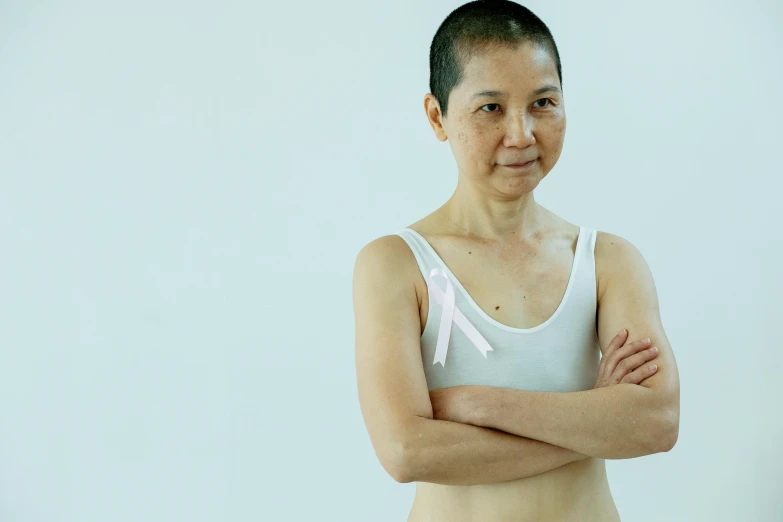 a woman posing for a picture with her arms crossed, inspired by Zhang Kechun, unsplash, sōsaku hanga, partially bald, white ribbon, posing together in bra, older woman