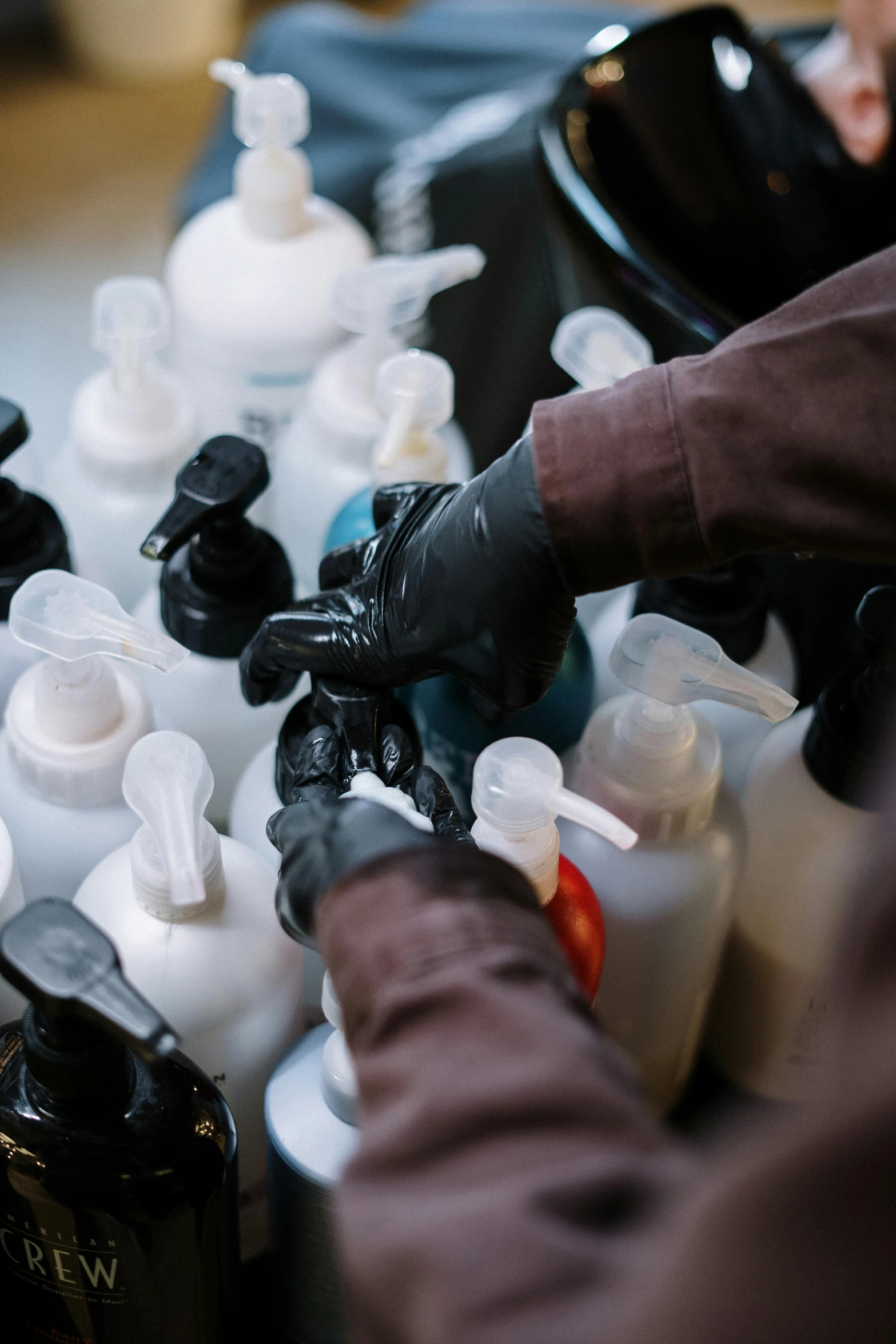 a close up of a person working on a machine, bottles covered in wax, wearing gloves, paul barson, thumbnail