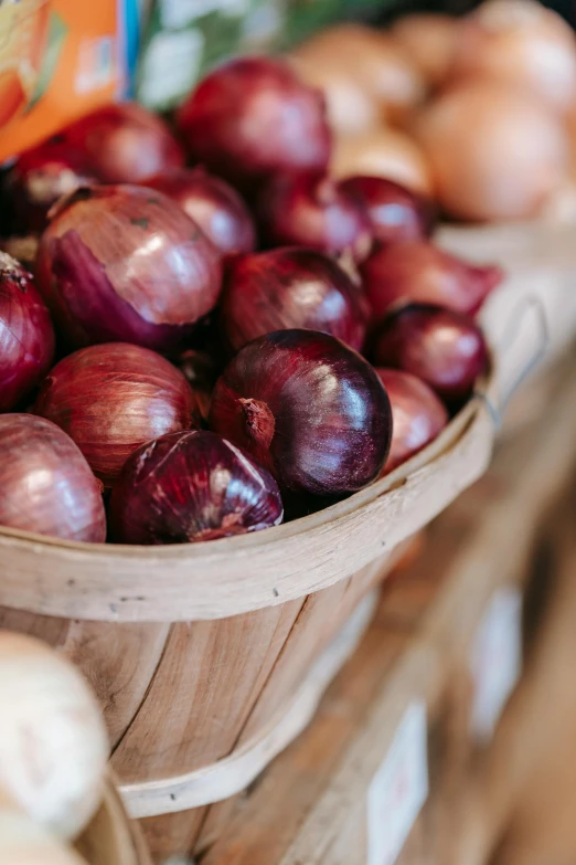 a basket of onions sitting on top of a table, purple crimson color scheme, upon a peak in darien, zoomed in, high quality product image”
