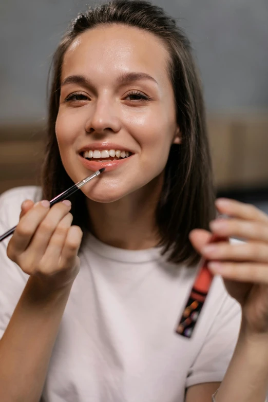 a woman brushing her teeth with a toothbrush, by Adam Marczyński, trending on pexels, hyperrealism, putting on lipgloss, smiling young woman, wearing professional makeup, painted