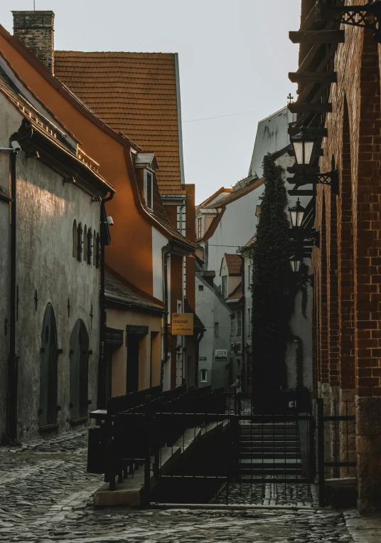 a cobblestone street in an old european town, pexels contest winner, gray and orange colours, view from the side”, tallinn, light academia aesthetic
