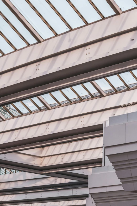 a man riding a skateboard up the side of a ramp, inspired by Andreas Gursky, trending on pexels, light and space, skylight open ceiling, detail structure, picture of a loft in morning, canopies