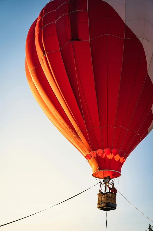 a red and white hot air balloon flying in the sky, red and orange color scheme, red color scheme, subtle details, color”
