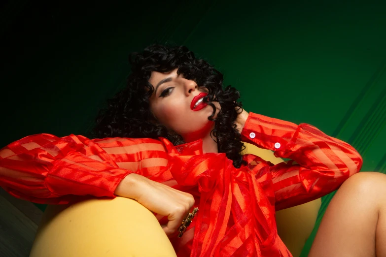 a woman sitting on top of a yellow ball, an album cover, pexels, wearing a red outfit, curls, karla ortiz, promotional image