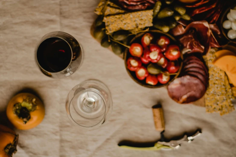 a table topped with a plate of food and a glass of wine, by Daniel Lieske, pexels contest winner, harvest, unfinished, ad image, hunting