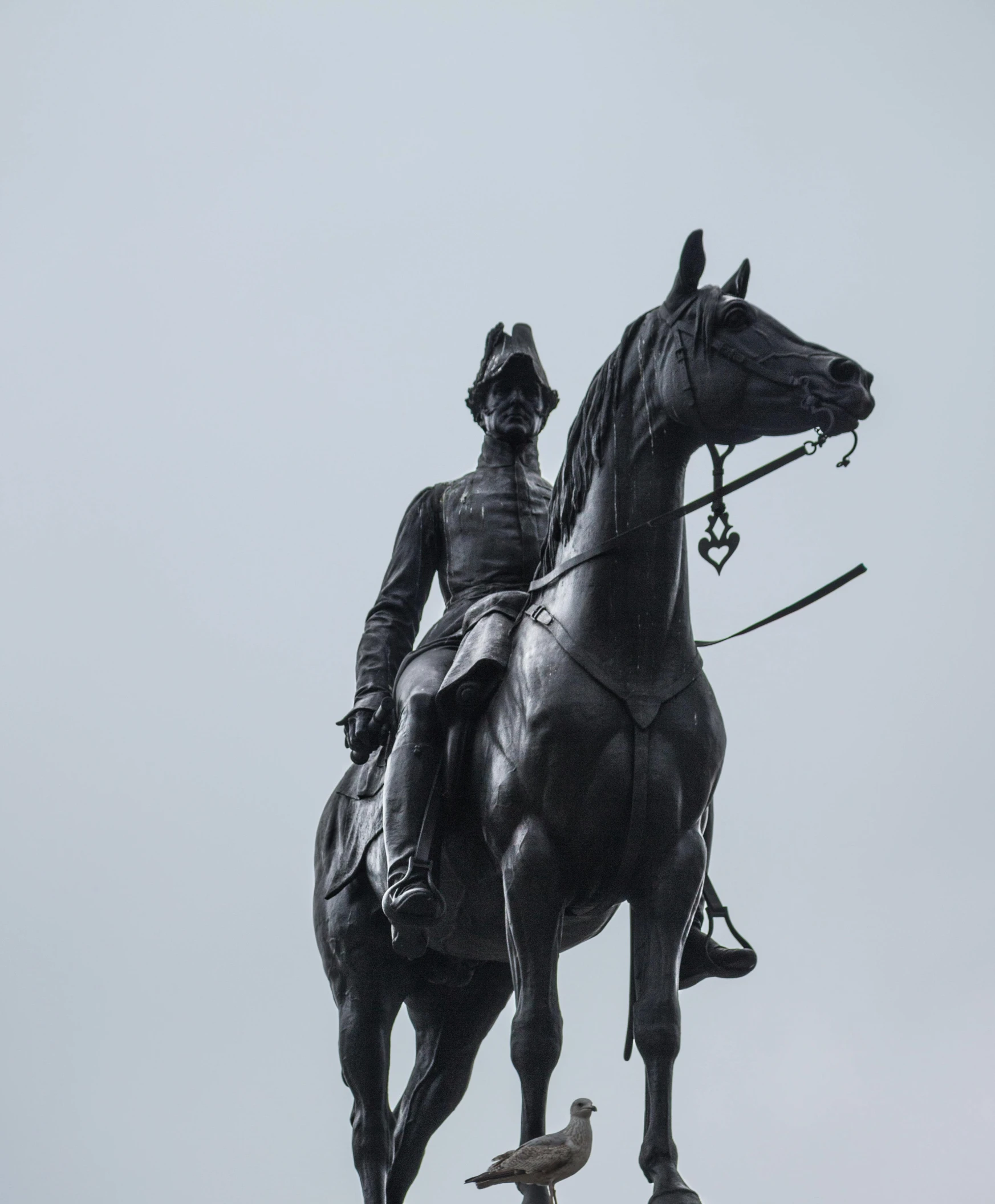 a statue of a man riding on the back of a horse, inspired by Prince Hoare, unsplash, wearing a general\'s uniform, square, grey skies, black man