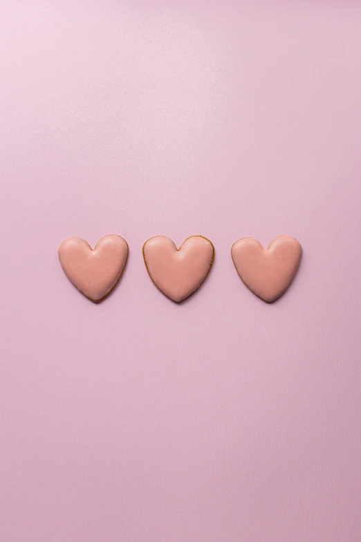 three hearts in a row on a pink background, trending on pexels, cookies, thumbnail, brown, enamel