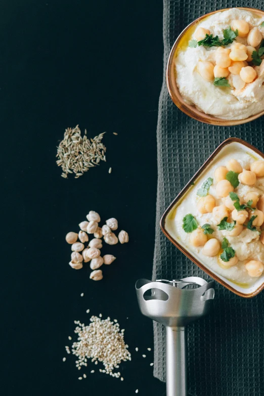 a couple of bowls of food sitting on top of a table, by Daniel Lieske, trending on unsplash, renaissance, middle eastern skin, yeast, promo image