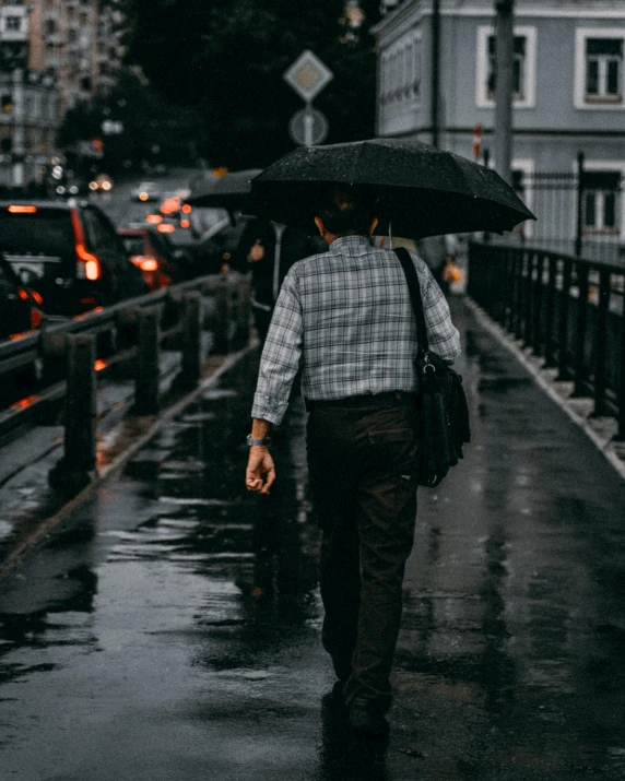 a man walking in the rain with an umbrella, unsplash contest winner, romanticism, non-binary, dressed in a gray, instagram story, humid evening