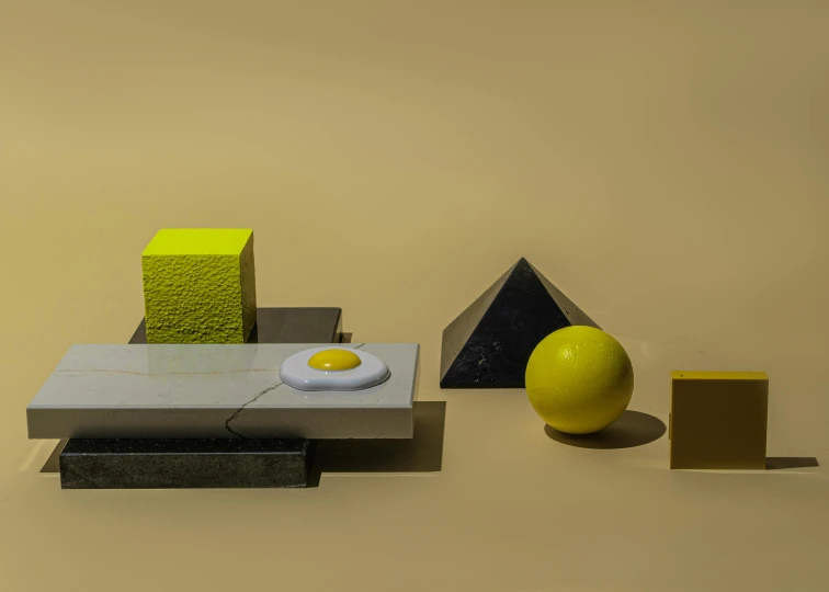 a yellow egg sitting on top of a table, an abstract sculpture, inspired by Bauhaus, trending on polycount, hypermodernism, cubes on table, made of liquid metal and marble, a still life of a microwave, square shapes