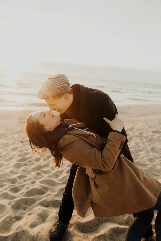 a couple kissing on the beach at sunset, pexels contest winner, light toned, winter, playful, headshot