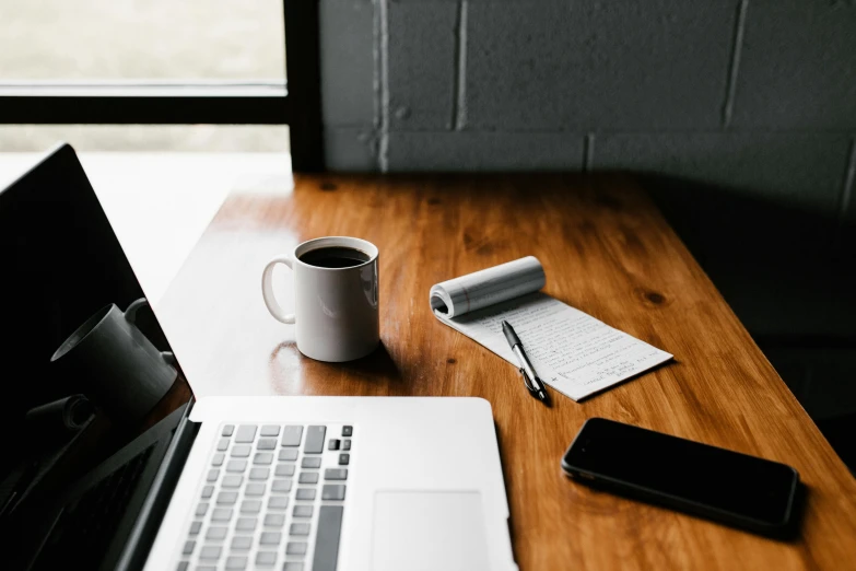 a laptop computer sitting on top of a wooden desk, trending on pexels, private press, table in front with a cup, 9 9 designs, brown, no - text no - logo