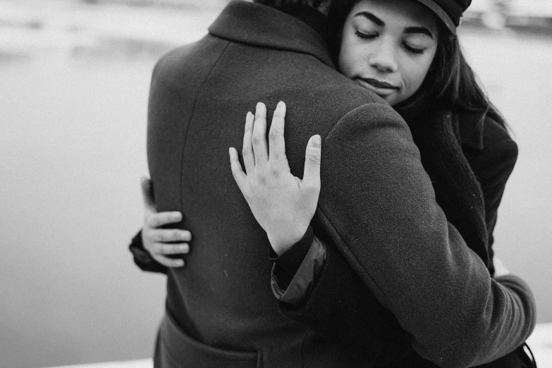 a black and white photo of a woman hugging a man, a black and white photo, by Emma Andijewska, pexels, visual art, the ring, 💣 💥💣 💥, anato finnstark and alena aenami, gentleman