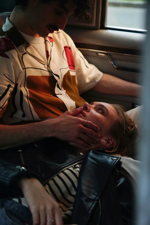 a man sitting next to a woman in a car, inspired by Nan Goldin, trending on pexels, hyperrealism, passed out, wes anderson and gucci, splash image, embracing