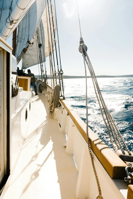 a view of the ocean from the deck of a sailboat, renaissance, explorer, looking off to the side, in majestic