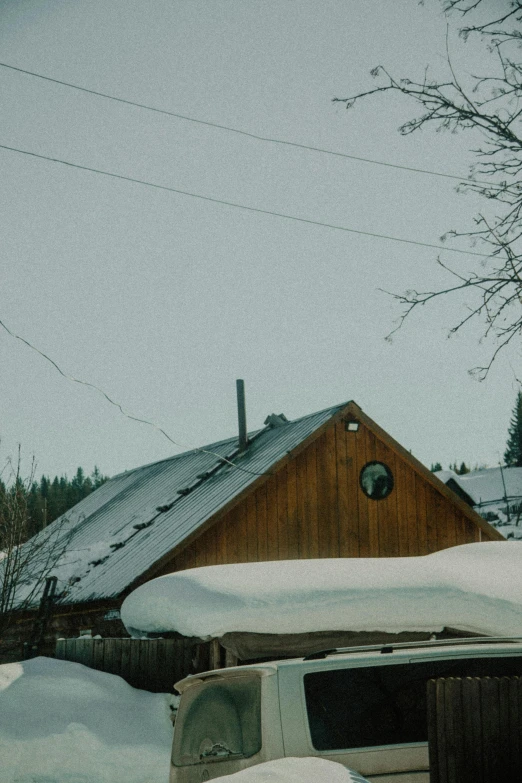 a truck that is sitting in the snow, a picture, unsplash, simple gable roofs, 1990s photograph, cabin, whistler