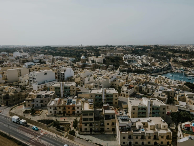an aerial view of a city with lots of buildings, pexels contest winner, hurufiyya, looking partly to the left, seaview, middle eastern details, slight overcast weather