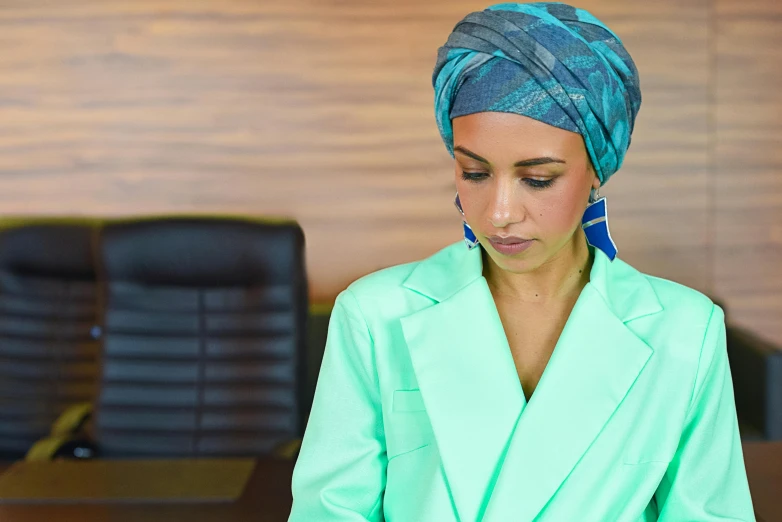 a woman wearing a turban looking at a cell phone, pexels contest winner, hurufiyya, teal suit, female in office dress, profile image, youtube thumbnail