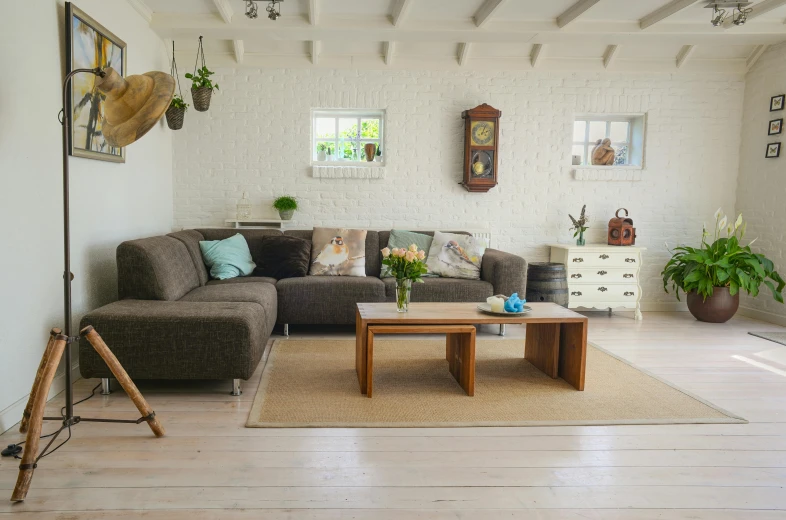 a living room with a couch and a coffee table, a photo, pexels contest winner, light and space, homes and gardens, wooden floor, storybook style, well decorated