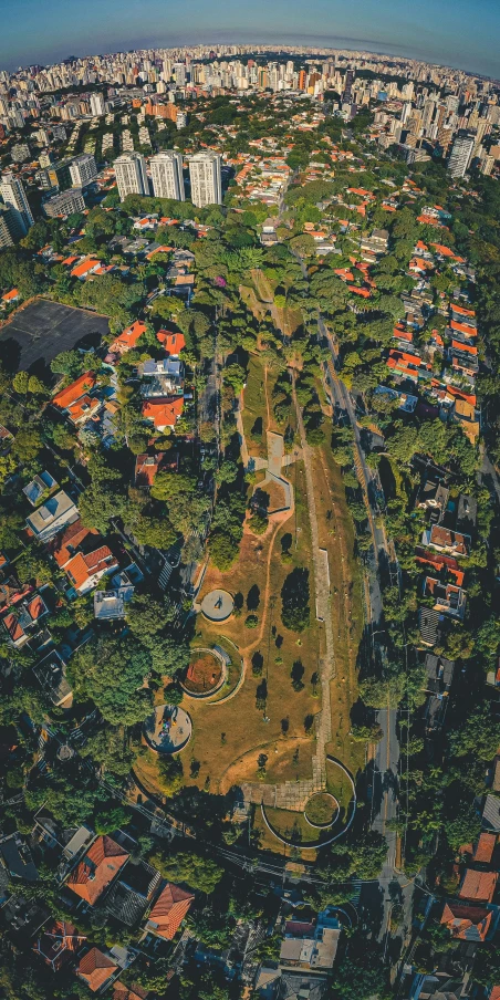 an aerial view of a city from a bird's eye view, a screenshot, by Adam Marczyński, pexels contest winner, sunny day in a park, são paulo, peaceful suburban scene, bird\'s eye view