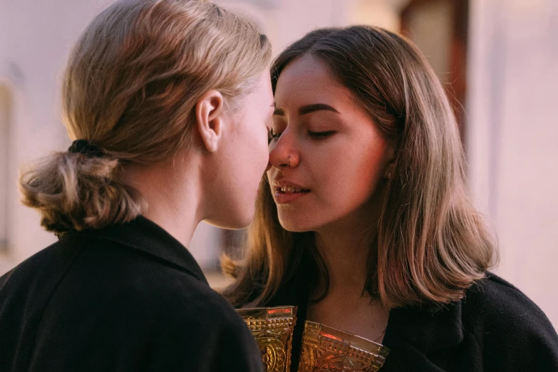 a couple of women standing next to each other, by Julia Pishtar, trending on pexels, hyperrealism, lesbian kiss, orthodox, imogen poots paladin, multiple stories