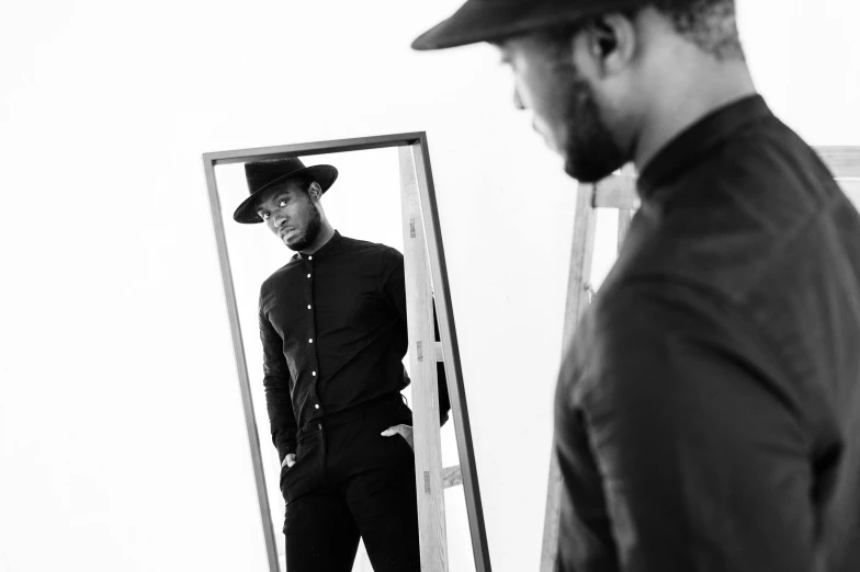 a man in a hat standing in front of a mirror, by Clifford Ross, unsplash, conceptual art, sharp black skin, square, wearing black dress and hat, kevin hart