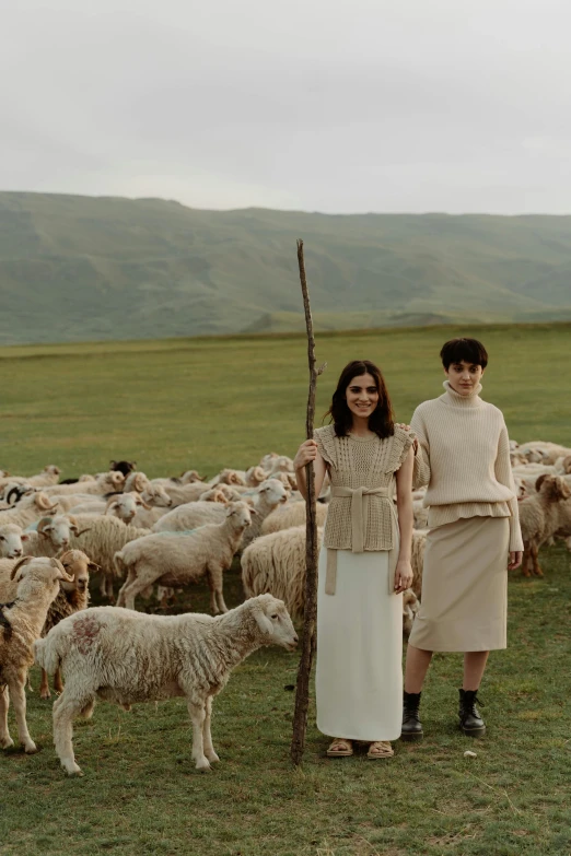 a man and a woman standing in front of a herd of sheep, inspired by Vanessa Beecroft, trending on pexels, renaissance, kurdistan, young women, georgian dress, production photo