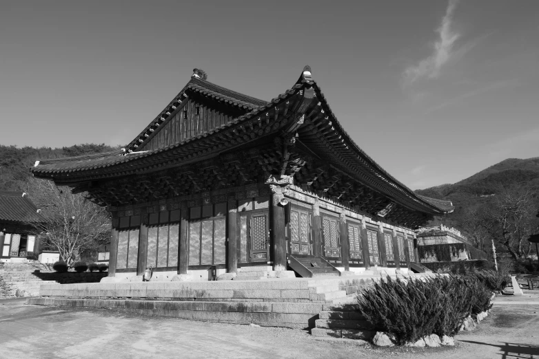 a black and white photo of a building, inspired by Kim Hong-do, korean traditional palace, 2 0 2 2 photo, wooden buildings, beautiful sunny day
