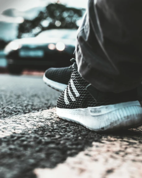 a person standing on the side of a road, addidas, on the sidewalk, profile image
