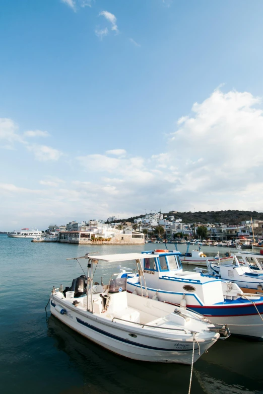 a couple of boats that are sitting in the water, athene, whitewashed buildings, docked at harbor, panoramic