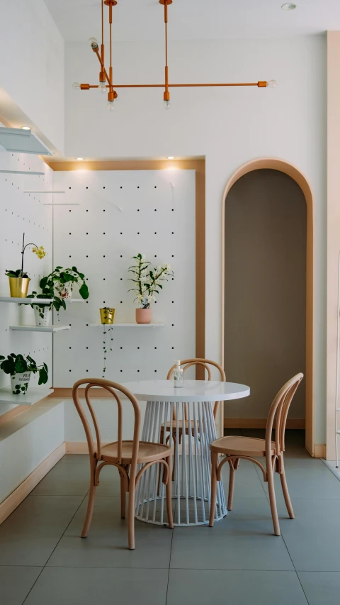 a kitchen with a table and chairs in it, inspired by Constantin Hansen, trending on unsplash, light and space, pink arches, storefront, lulu chen, diecut