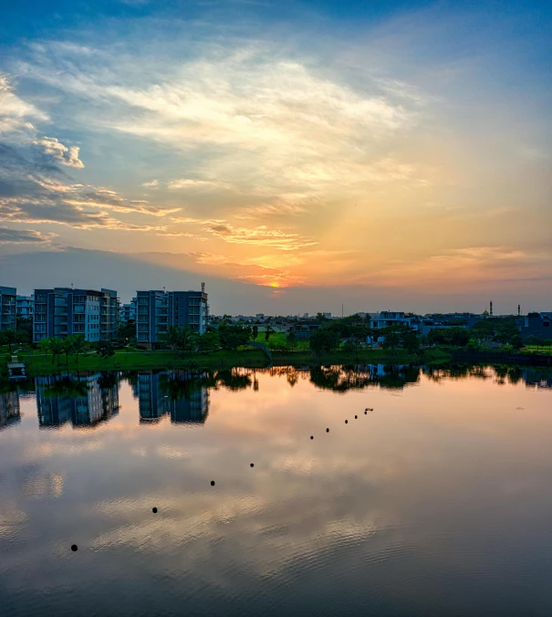 a body of water with buildings in the background, pexels contest winner, 8k hdr sunset lit, today\'s featured photograph 4k, residential area, summer morning