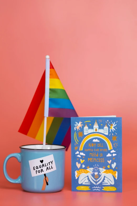 a cup of coffee with a rainbow flag next to it, poster art, emma bridgewater and paperchase, blue themed, lgbtq, full subject shown in photo