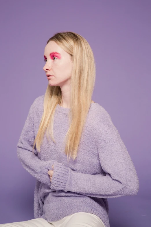 a woman in a grey sweater and white pants, an album cover, inspired by Maud Naftel, trending on pexels, with vivid purple eyes, looking away from camera, portrait of kim petras, britt marling style 3/4