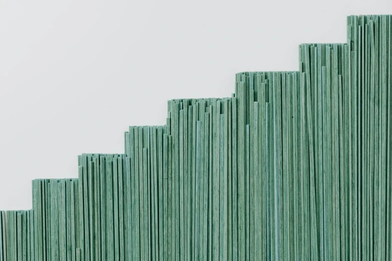 a person sitting on a bench in front of a green sculpture, an abstract sculpture, by Attila Meszlenyi, trending on unsplash, analytical art, highly detailed texture render, sleek spines, teal paper, close up high detailed