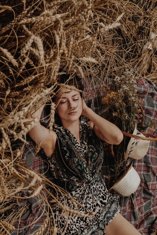 a woman laying on a blanket in a field, a portrait, pexels contest winner, renaissance, dried plants, cornucopia, promotional image, patterned clothing