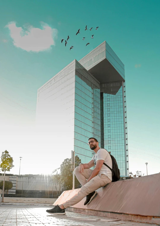 a man sitting on a ledge in front of a building, avatar image, diego fernandez, capital plaza, ((monolith))