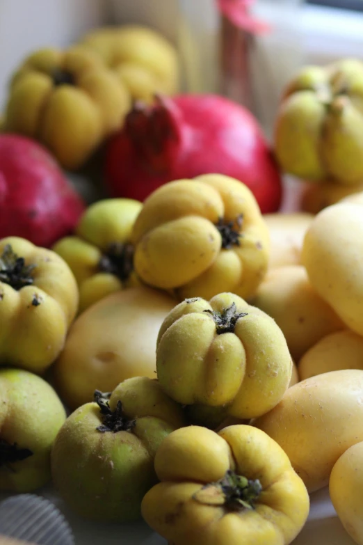 a pile of fruit sitting on top of a table, nuttavut baiphowongse, up close, varying ethnicities, yellow