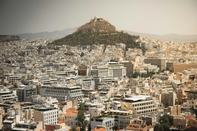 a view of a city with a hill in the background, pexels contest winner, neoclassicism, square, greek, brown, commercial photo