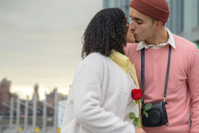 a man giving a woman a kiss on the cheek, pexels contest winner, holding a rose, standing on a rooftop, essence, ariel perez