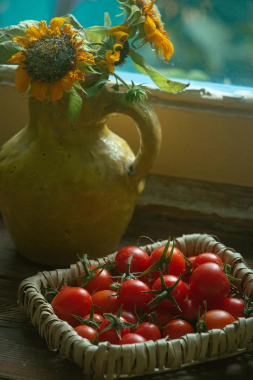 a basket of tomatoes next to a vase of sunflowers, slide show, soft window light, uncropped, pasta