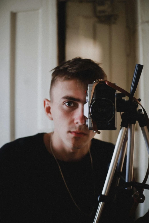 a man taking a picture of himself with a camera, by Jacob Toorenvliet, pexels contest winner, video art, halfbody headshot, 18 years old, discord profile picture, serious look