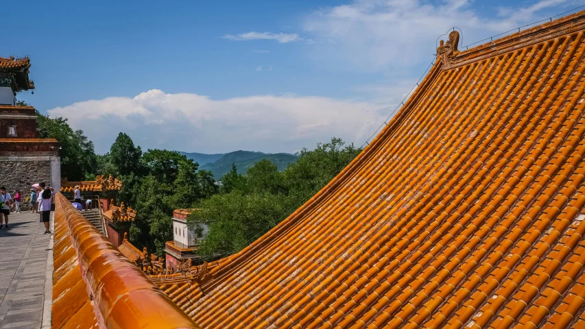 a group of people standing on top of a roof, inspired by An Zhengwen, pexels contest winner, cloisonnism, orange roof, view from side, square, landscape photo