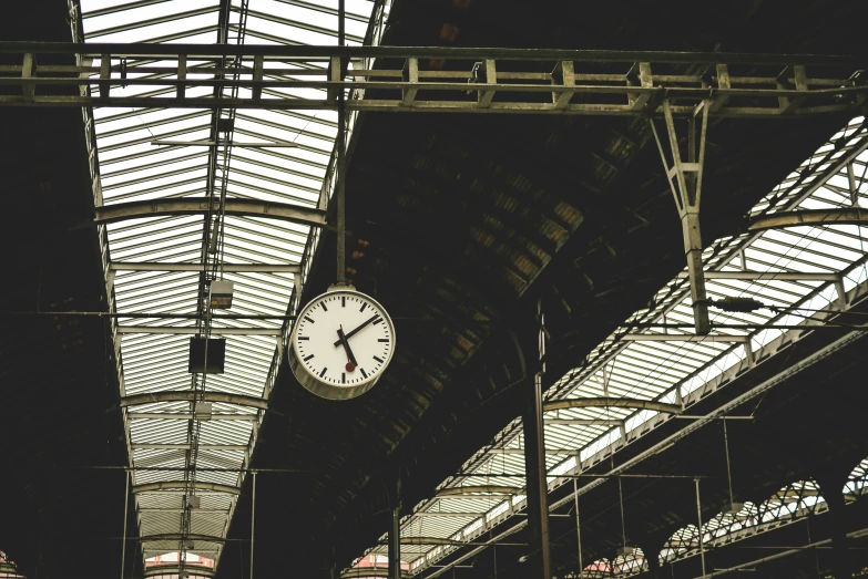 a clock hanging from the ceiling of a train station, inspired by Thomas Struth, pexels contest winner, square, thumbnail, white, glasgow